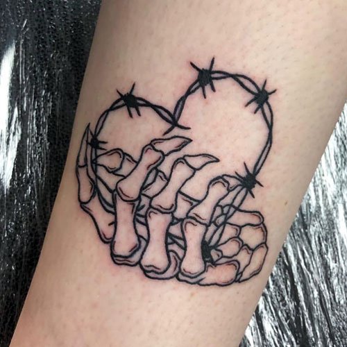 Skeleton Hand Holding Heart Tattoo